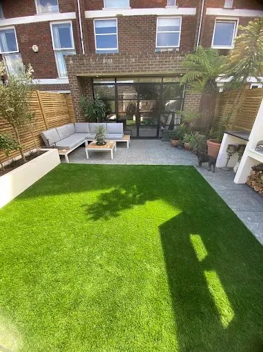 Landscaped rear garden with patio, planting and artificial lawn
