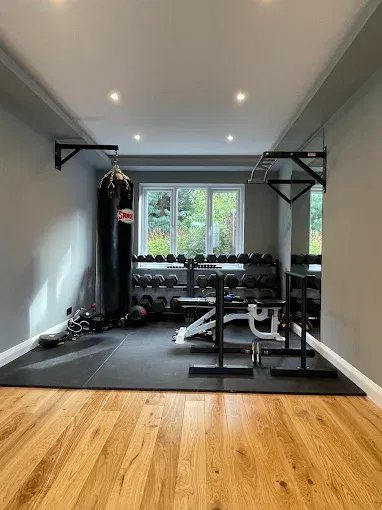 Completed home gym with recessed lighting and fitted training equipment